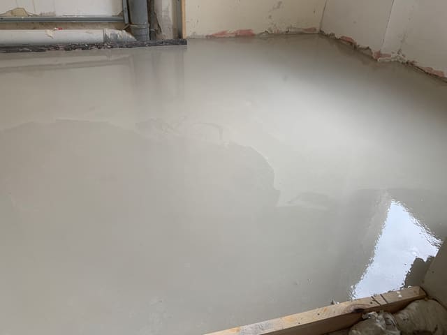 Self-levelling floor screed poured ahead of new flooring
